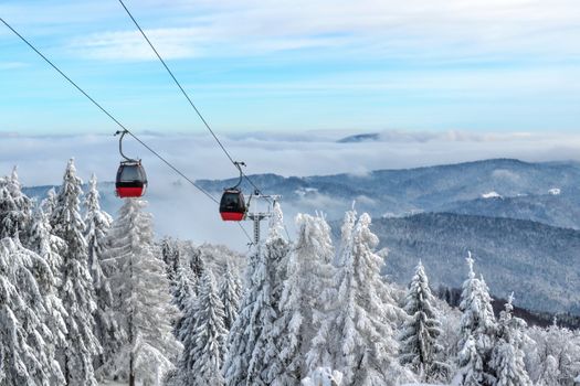 Gondola ski lift on a background of a picturesque winter mountain