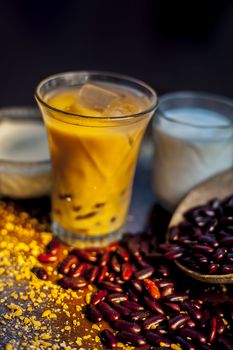 Red bean or kidney bean smoothie in a glass along with some red bean paste, banana, yogurt, milk, and oatmeal. Vertical shot.