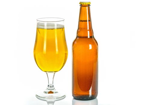 A glass and a bottle of cold lager beer isolated on white