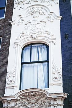 Architectural detail of a building on the main city center street of Amsterdam in Netherlands, european architecture