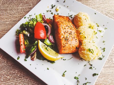 Grilled salmon, mashed potatoes and salad for lunch, served meal