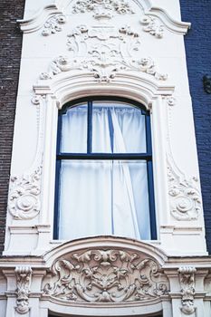 Architectural detail of a building on the main city center street of Amsterdam in Netherlands, european architecture