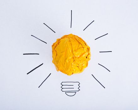 Inspiration concept crumpled color paper light bulb metaphor for good idea.