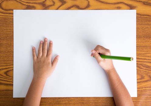 childs hands drawing on a blank paper