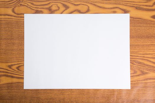 White blank paper on wood background