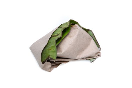 nasi lemak, a traditional malay curry paste rice dish served on a banana leaf