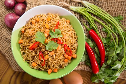 A Bowl of instant noodles on wooden table