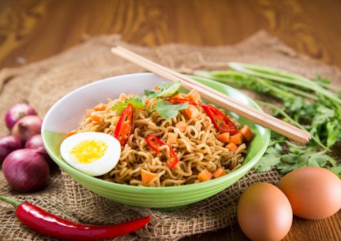 A Bowl of instant noodles on wooden table