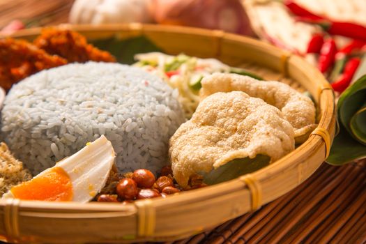 Nasi kerabu, popular Malay rice dish. Blue color of rice resulting from the petals of butterfly-pea flowers. Traditional Malaysian food, Asian cuisine.