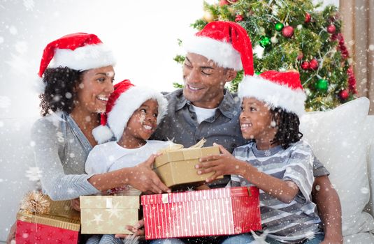 Composite image of Family celebrating Christmas at home against snow