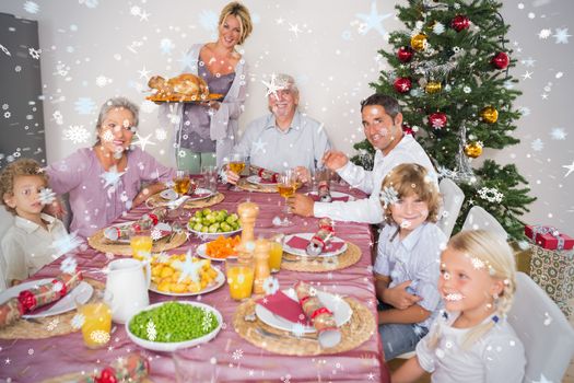Composite image of Mother bringing turkey to dinner table against snow