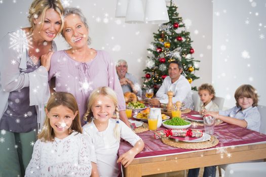 Composite image of Three generations of women at christmas time against snow falling