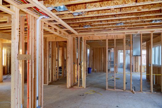 Wooden beams and wall to ceiling framed building under construction interior residential home