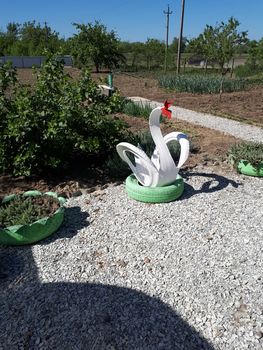 Craft from a rubber tire - a white swan. Decorations in the garden.