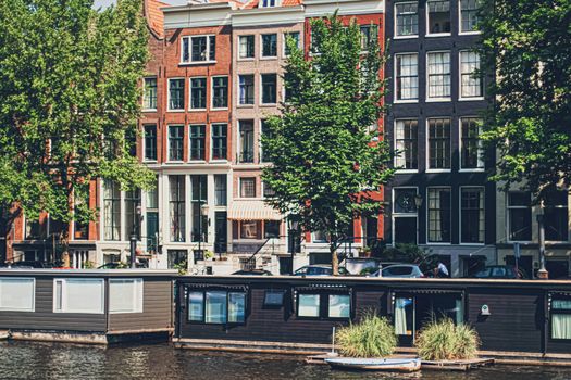 Main downtown street in the city center of Amsterdam in Netherlands on sunny day