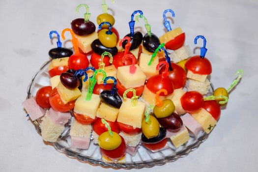 a Salad assorted, on plastic sticks vegetables and cheese.