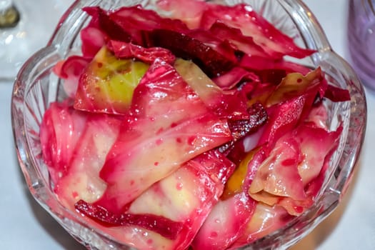 Cabbage leaf salad with beetroot. The salad is in a plate on the table.