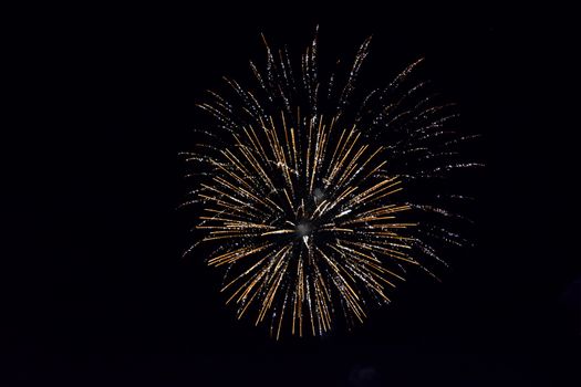 Festive salute in the night sky. Explosions of fireworks and pyrotechnics in the sky.