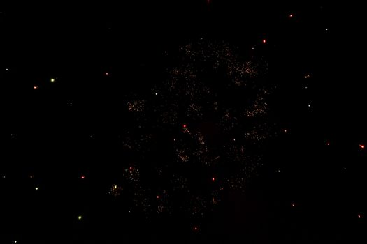 Festive salute in the night sky. Explosions of fireworks and pyrotechnics in the sky.