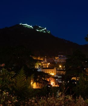 Evening view of the Portuguese town of Sintra with the Moorish fortress on the hilltop above the city