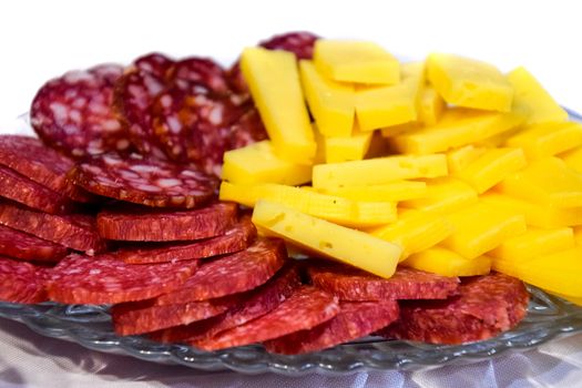 Sausage and cheese on a plate. table setting with sausages and cheeses.