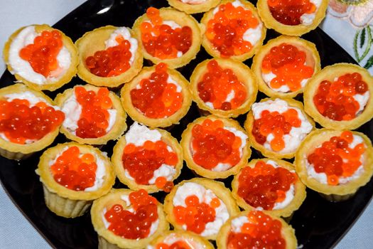 Waffle cups with mayonnaise and red caviar. Waffle cups with mayonnaise and red caviar.