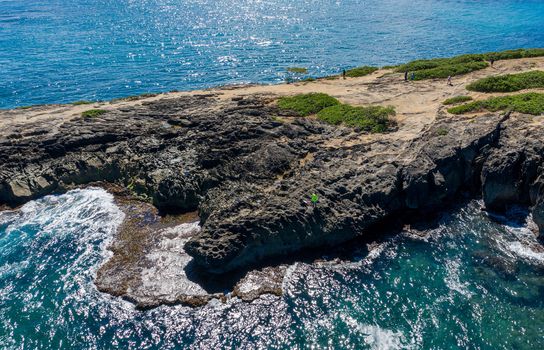 Coastline off La'ie Point on Oahu, Hawaii with sea angler on the headland