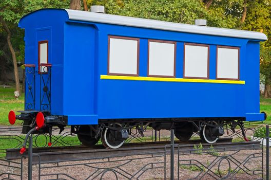 Old passenger train or rail car at outdoors pedestal.