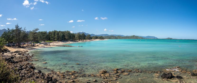 Panorama of the wide sandy Kailua Beach with mountains in background on east coast of Oahu in Hawaii