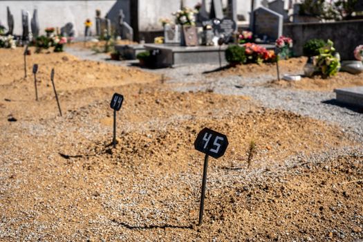 Markers for the positioning of new grave plots in the ground in a catholic cemetery in Portugal