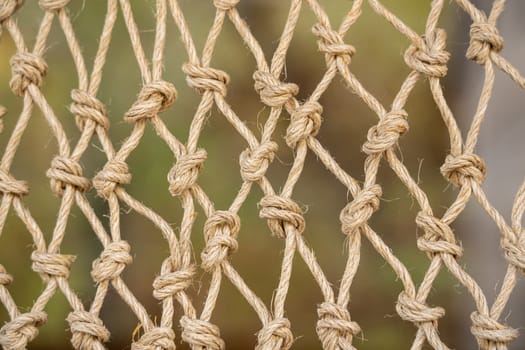 Close up of the knots on a traditional fishing net made by knotting ropes together