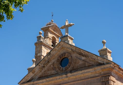 Detail of the bell tower and stork bird nest on the roof of San Pablo church in Salamanca Spain