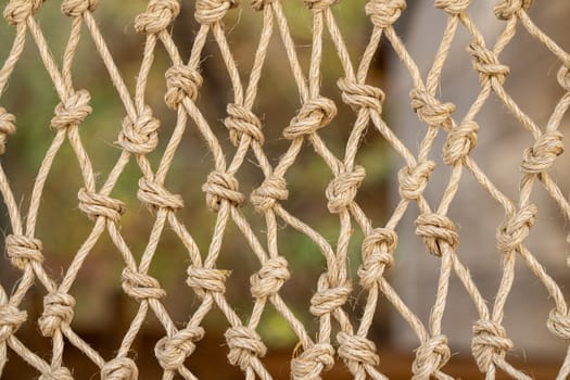 Close up of the knots on a traditional fishing net made by knotting ropes together