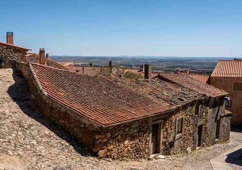 Old stone houses and narrow street in the ancient town of Castelo Rodrigo in Portugal