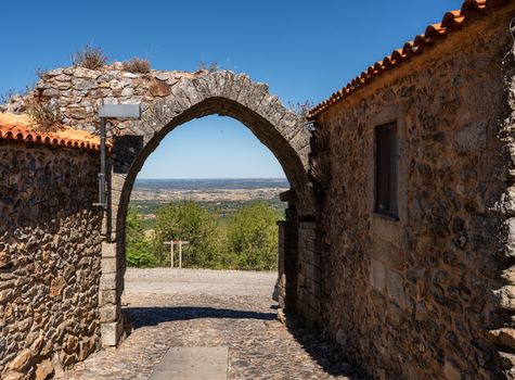 Old stone wall and arch around the houses and narrow streets in the ancient town of Castelo Rodrigo in Portugal