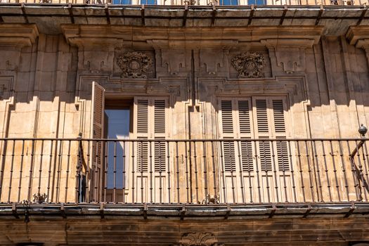 Ornate balconies and stone carvings around the windows and doors of apartments in Plaza Mayor in Salamanca