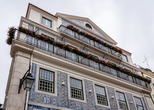 Decorative ceramic tiles on a large house with balconies in downtown Lisbon, Portugal