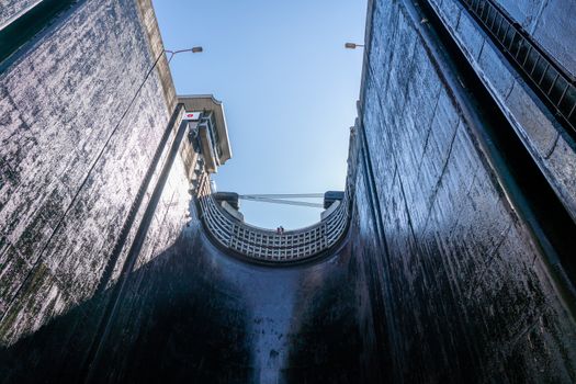 View towards the sky inside the very deep lock of the Barragem do Carrapatelo on Douro River in Portugal
