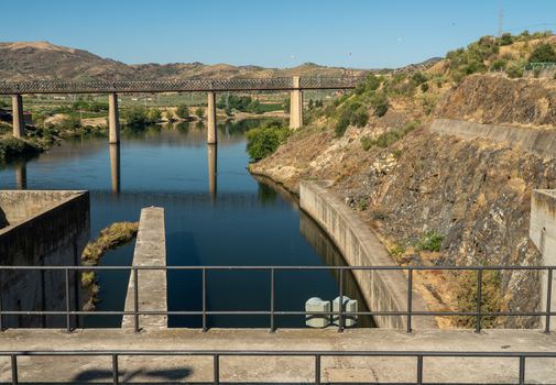 Barragem do Pocinho dam on the Douro river in Portugal as cruise boat waits by lock gates