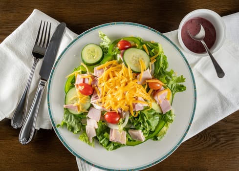 From above view of house or chef salad takeout food plated at home with napkin