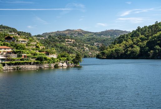 Modern homes and terraces come down to riverbank of Douro river near Viseu in Portugal