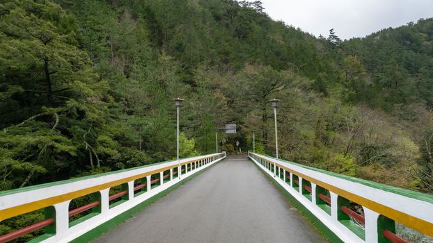 The landscape of road bridge with forest mountain at Wuling farm in taichung city, Taiwan.