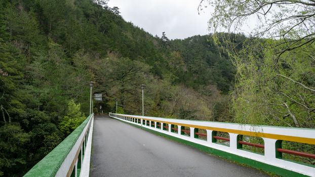 The landscape of road bridge with forest mountain at Wuling farm in taichung city, Taiwan.