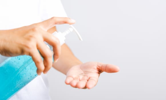 Closeup Hand Asian young woman applying pump dispenser sanitizer alcohol gel on hand wash cleaning, hygiene prevention COVID-19 or coronavirus protection concept, isolated on white background