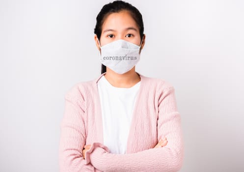 Asian beautiful woman wearing protection face mask against coronavirus standing crossed arm, studio shot isolated on white background with copy space, COVID-19 or corona virus concept