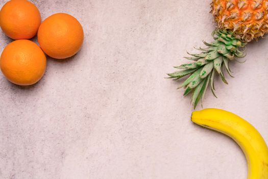 Tropical and Seasonal Summer Fruits. Pineapple Oranges and Bananas Arranged in corner of backgrounds, Healthy Lifestyle. Flat Lay