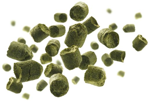 Green granulated hops levitate on a white background.