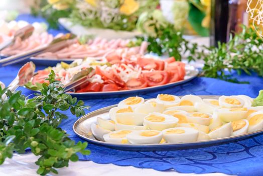 Luxurious Easter table setting full of greenery and flowers in the hotel