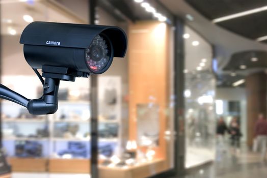 The concept of security through surveillance camera in the shopping center.