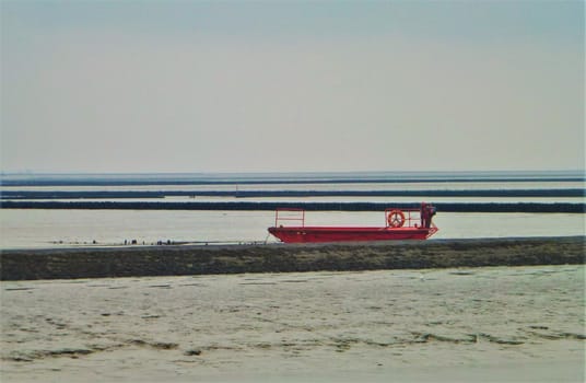 A red boat floating in the north sea